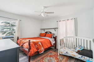 Bedroom with wood finished floors and ceiling fan