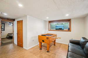 Game room featuring a textured ceiling and recessed lighting