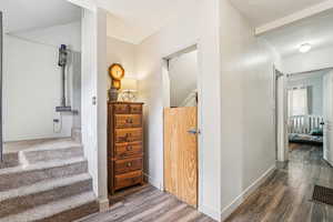 Corridor featuring wood finished floors and baseboards