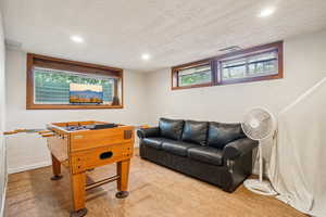 Playroom featuring recessed lighting, healthy amount of natural light, and a textured ceiling