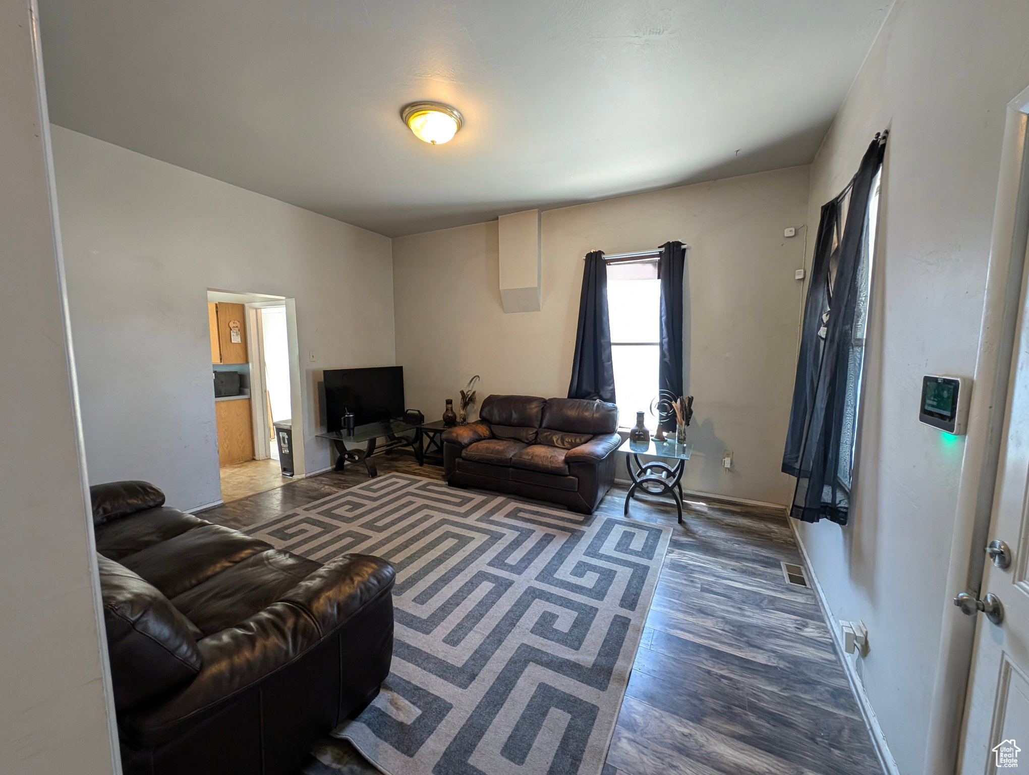 Living area with wood finished floors and baseboards