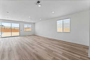 Empty room featuring light wood finished floors and recessed lighting