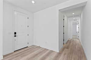 Entrance foyer featuring recessed lighting and light wood finished floors