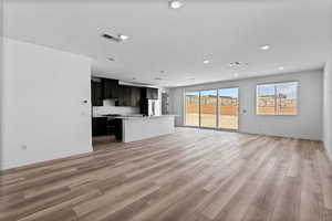 Unfurnished living room with light wood-style flooring and recessed lighting
