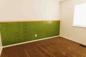 Carpeted bedroom 4 with a wainscoted wall