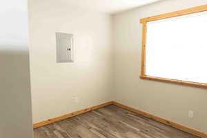 Unfurnished extra/spare room featuring LVP wood-style flooring and electric panel