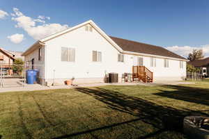 Back of property with a patio and a gate