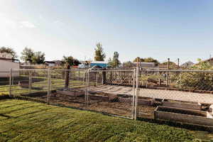 View of yard featuring a vegetable garden and a residential view