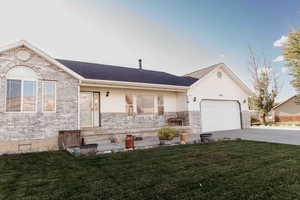 Ranch-style home with a porch, a front lawn, concrete driveway, an attached garage, and brick siding