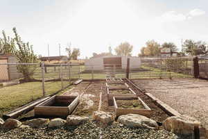 View of yard featuring a garden and an outdoor structure