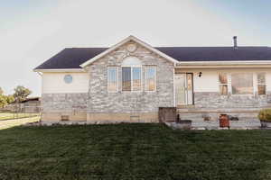 View of front facade featuring brick siding and roof with shingles