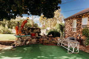 View of lawn with a patio area & back of home