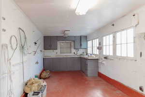 Garage/workshop gray cabinetry, and concrete floors