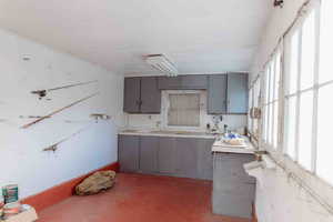 Garage/workshop w/ cabinets, finished concrete flooring, and light countertops