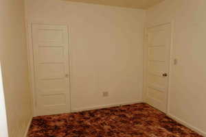 Bedroom with carpet and baseboards