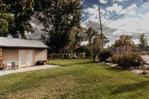 View of yard featuring a patio and french doors
