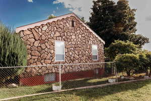 View of side of property featuring stone siding