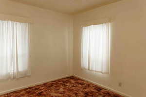 Bedroom featuring carpet flooring and baseboards