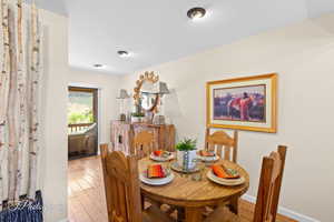 Dining space with hardwood / wood-style floors and baseboards
