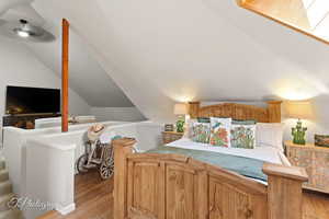 Bedroom featuring light wood-style floors and lofted ceiling