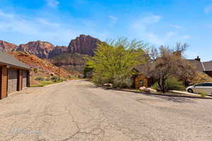 View of asphalt street featuring a mountain view