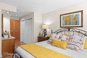 Bedroom featuring recessed lighting, light wood finished floors, and a closet