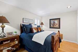 Bedroom with wood finished floors and recessed lighting