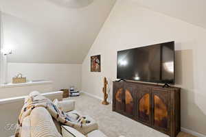 Living room with lofted ceiling and carpet