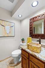 Half bath with vanity and toilet