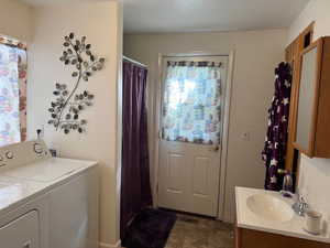 Laundry room with washer and clothes dryer