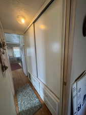 Bathroom featuring a textured ceiling and wood finished floors