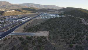 Aerial view of property and surrounding area featuring a mountain backdrop