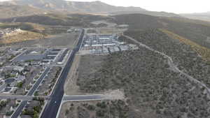 Aerial view of property and surrounding area with a mountainous background