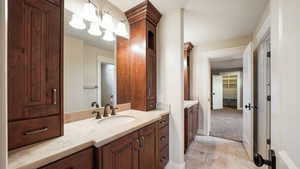 Bathroom featuring vanity and a closet