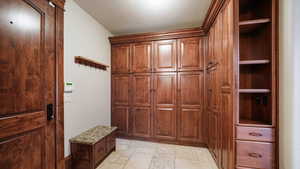 Mudroom featuring stone tile floors