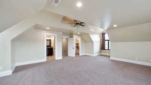 Bonus room with recessed lighting, light colored carpet, vaulted ceiling, and a ceiling fan