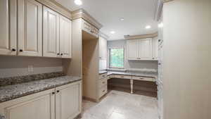 Washroom featuring recessed lighting, a desk, and stone tile flooring
