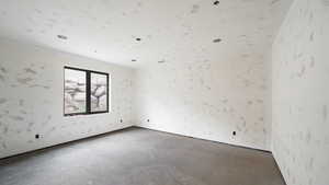 Spare room featuring concrete floors