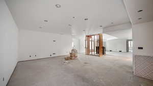 Spare room featuring unfinished concrete floors