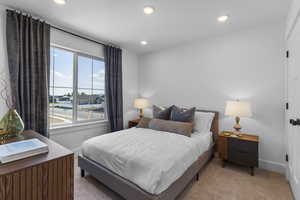 Carpeted bedroom with recessed lighting and baseboards