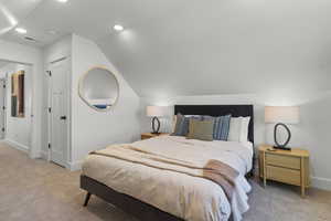 Bedroom featuring carpet, a closet, lofted ceiling, and recessed lighting