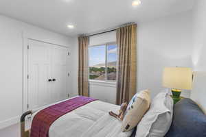 Bedroom with a closet, a mountain view, recessed lighting, and carpet flooring