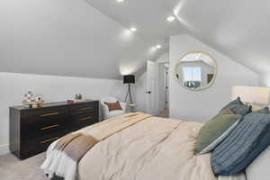 Bedroom featuring light colored carpet, vaulted ceiling, and recessed lighting