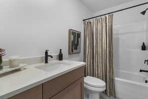 Full bath featuring vanity and shower / bathtub combination with curtain