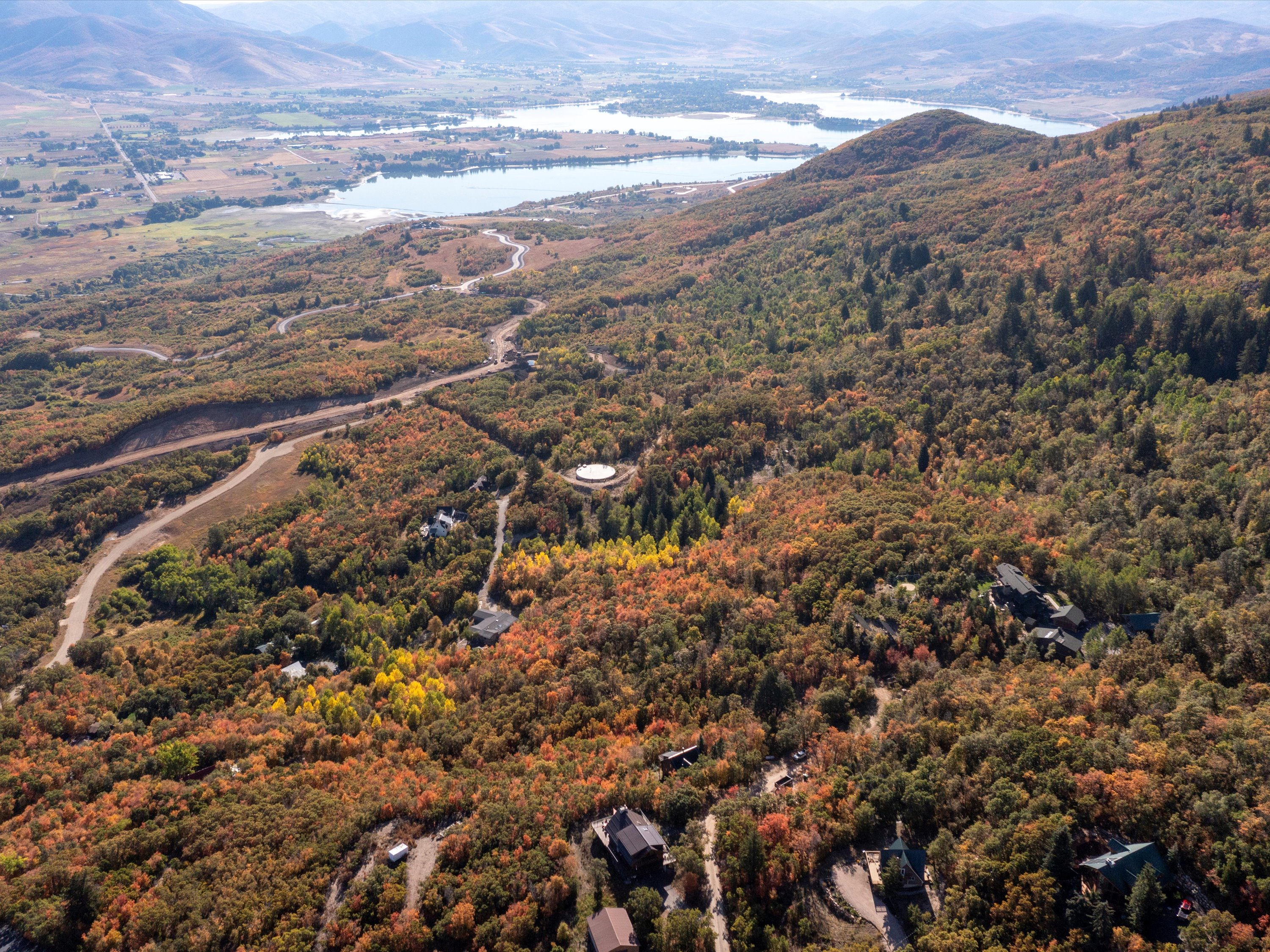 Drone / aerial view of a water and mountain view and a heavily wooded area