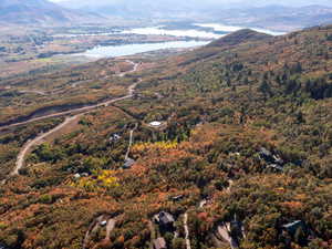 Drone / aerial view of a water and mountain view and a heavily wooded area