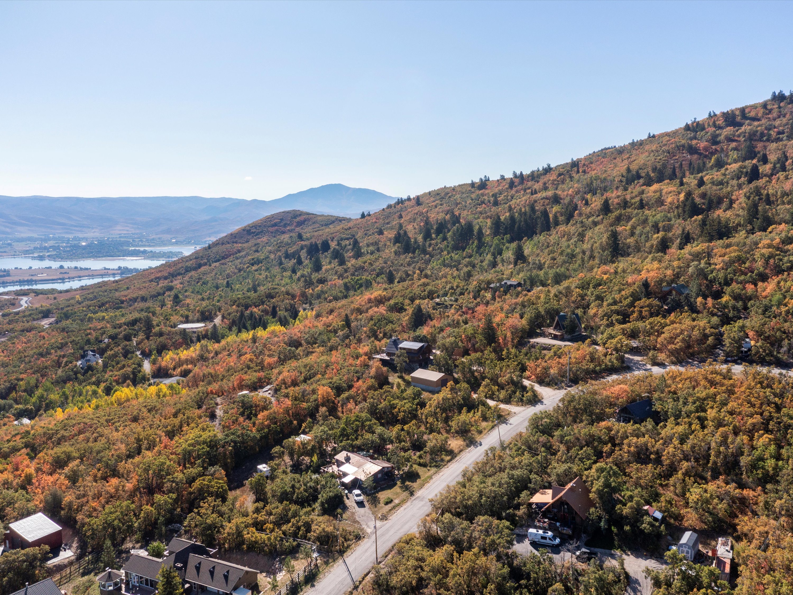 Bird's eye view of a water and mountain view and a heavily wooded area