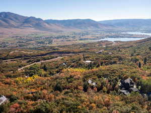 View of mountain background with a nearby body of water and a forest