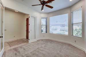 Spare room featuring light colored carpet, light tile patterned floors, a ceiling fan, and recessed lighting