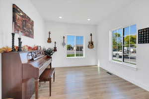 Living area with plenty of natural light, light wood-style floors, and recessed lighting